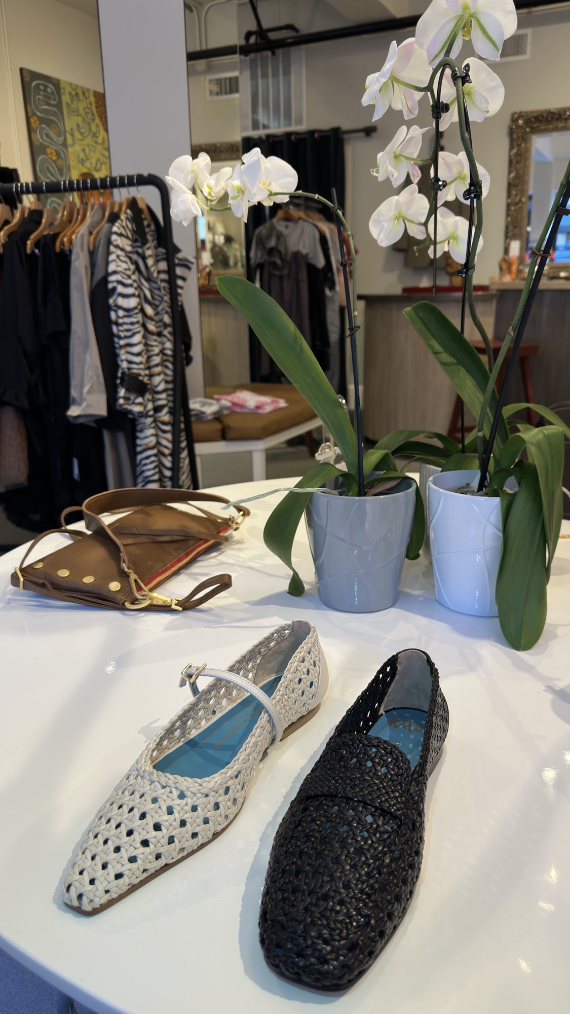 Woven flats on the display table at Zelda's, the shop floor behind