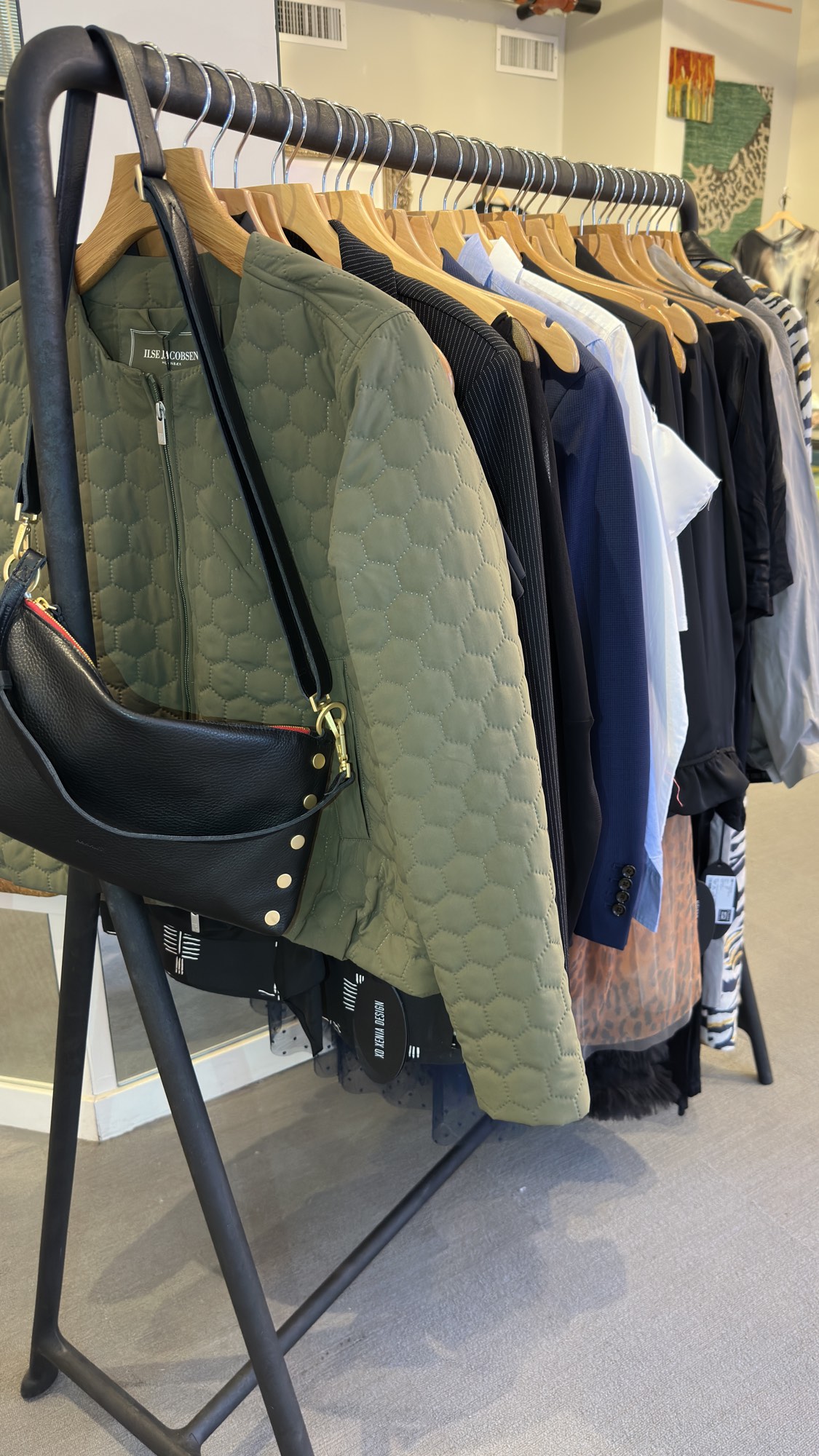 A rack of jackets and a shoulder bag at Zelda's