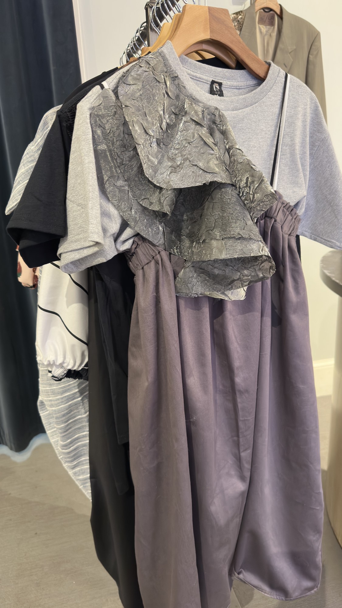 Draped dresses hanging on the rack at Zelda's